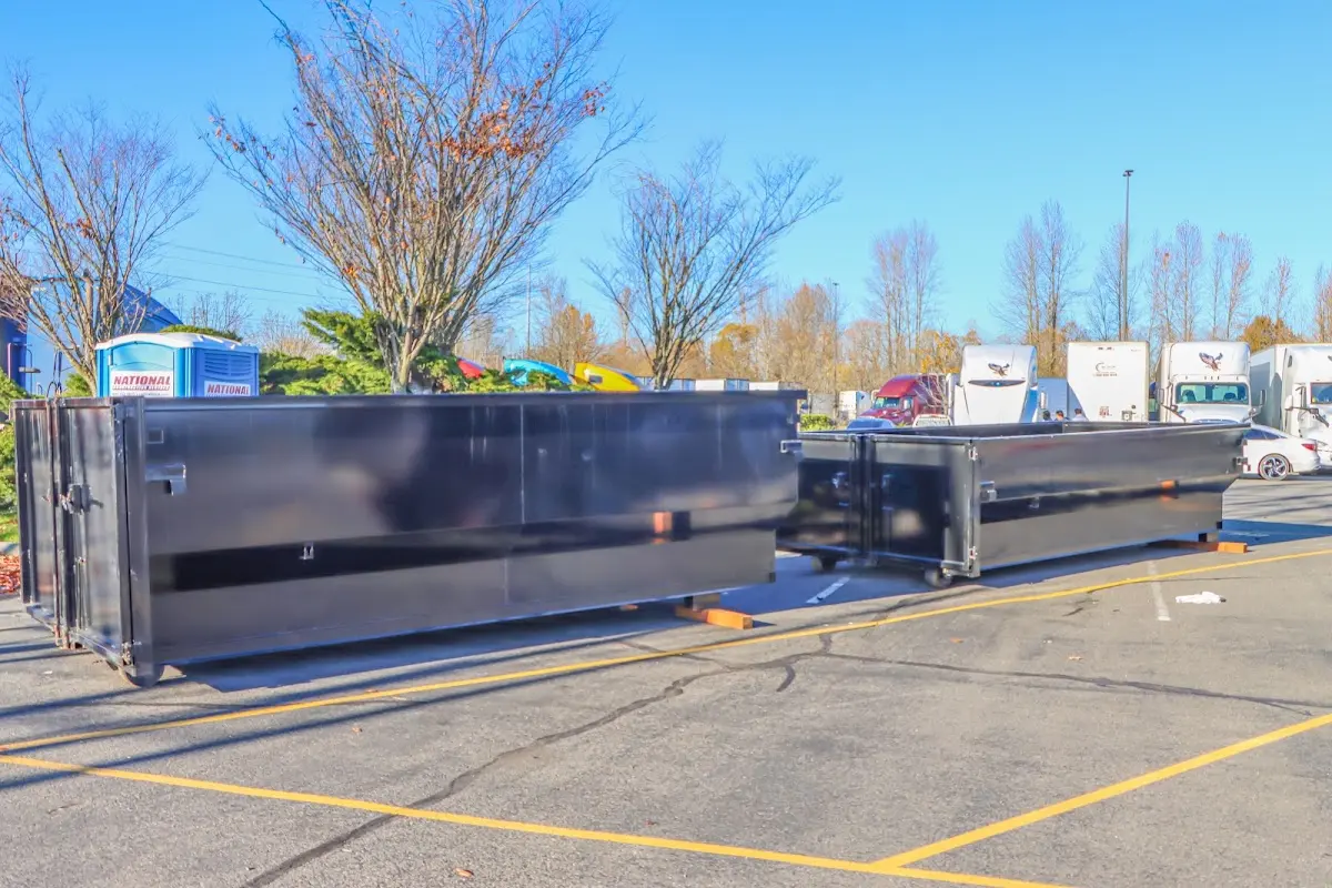 Professional dumpster rental service with roll-off container on residential driveway in Southbridge Town